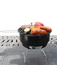 BBQ Croc charcoal COOL GRILL grilling a burger, sausage and vegetables on a table top